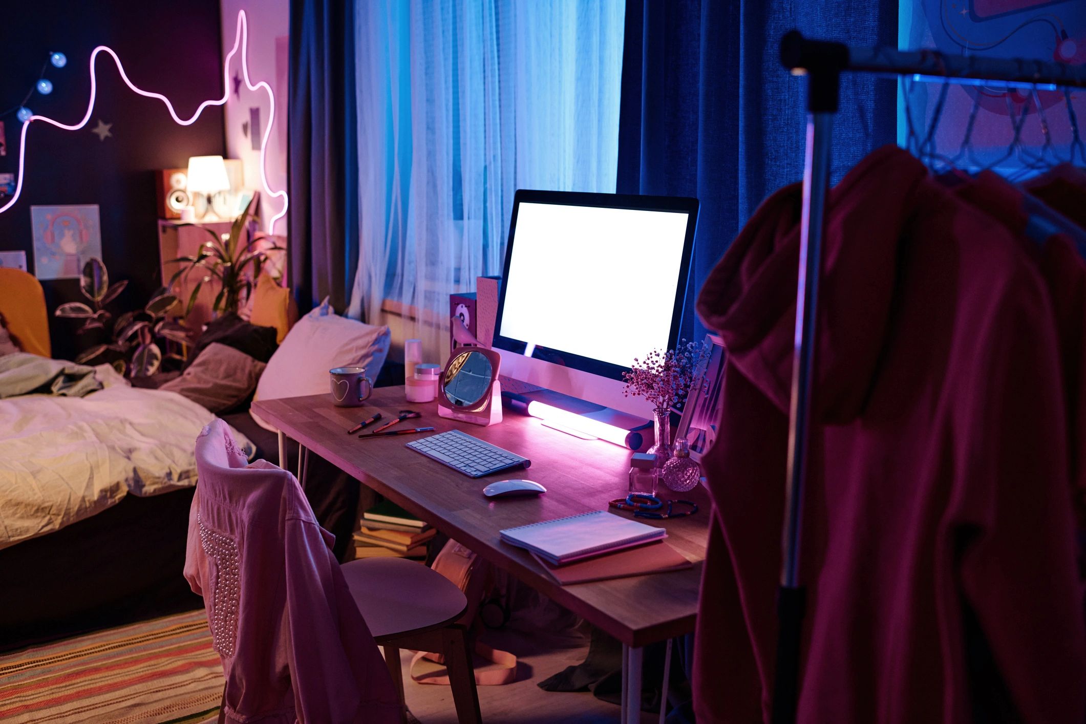 Computer desk with neon-lit gaming style setup