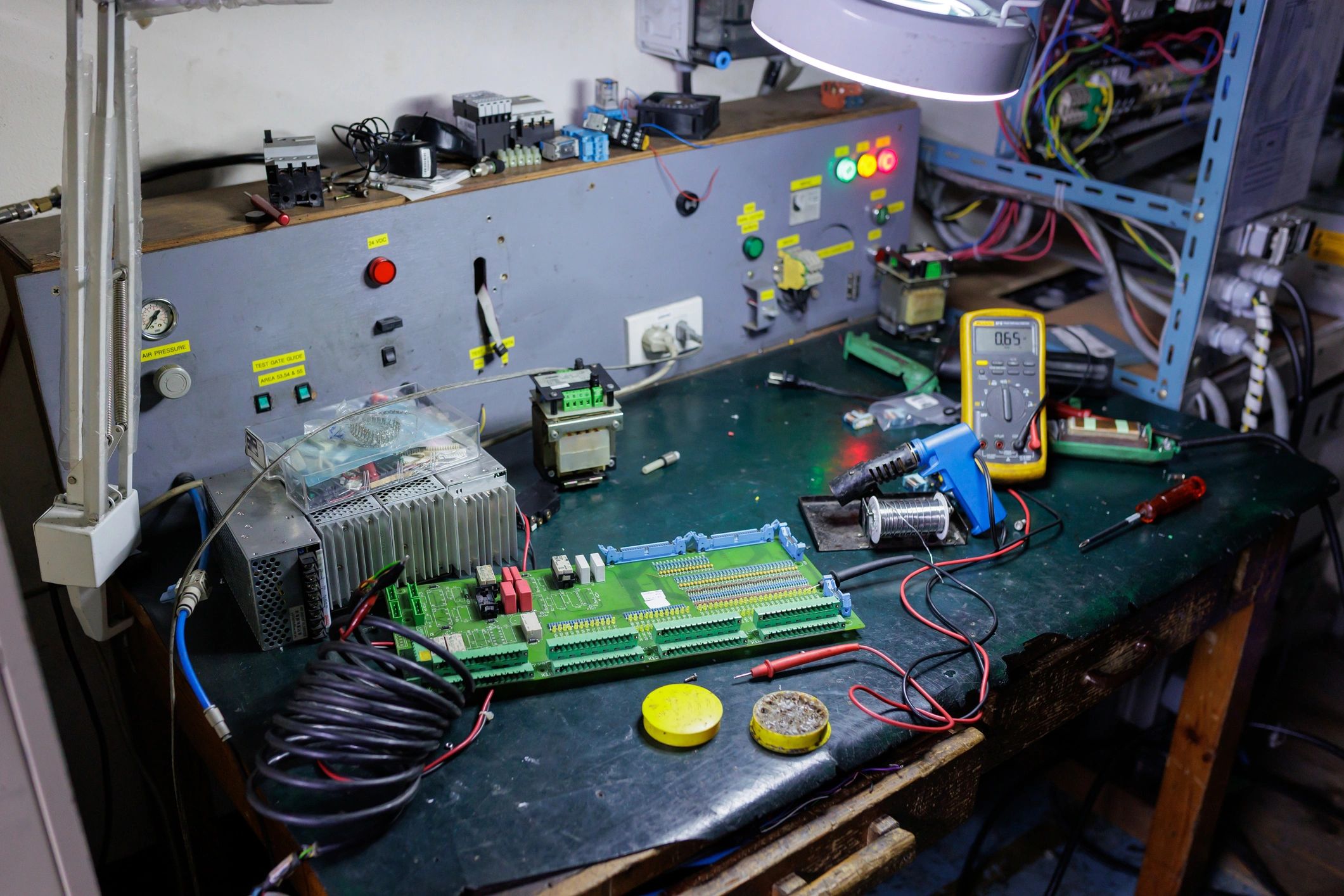 Electronics workshop with circuit board and testing equipment