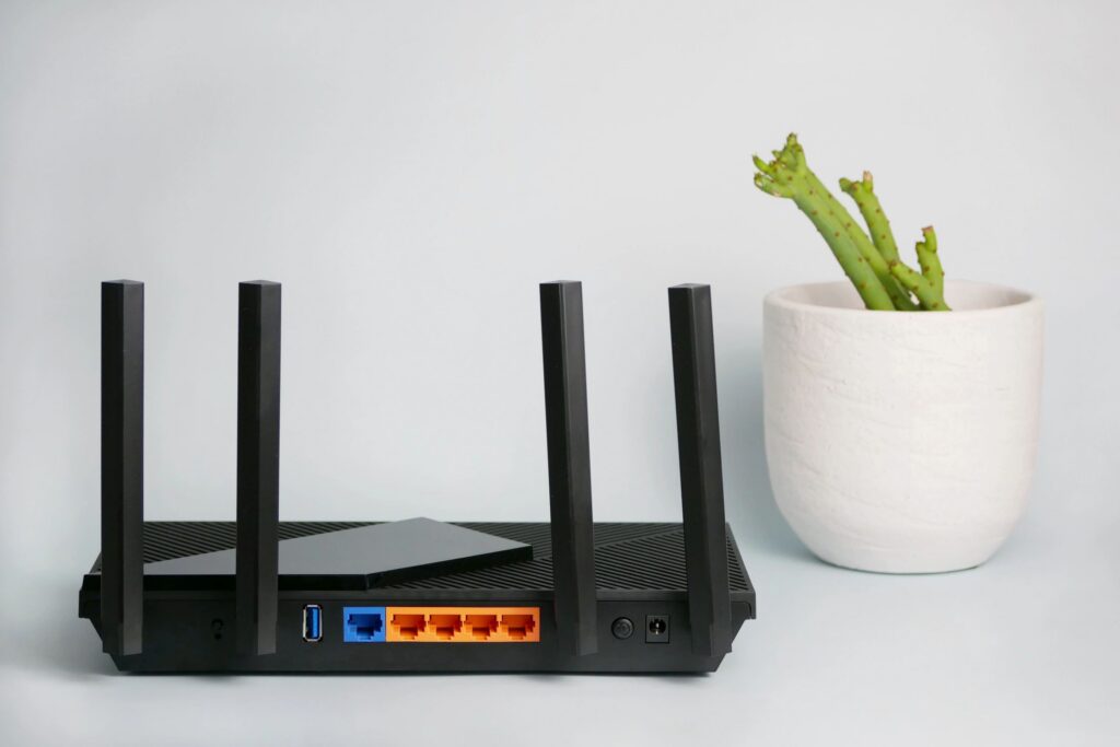 Black wireless router providing network technology for internet connection.