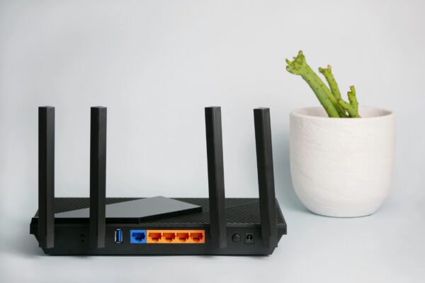 Black wireless router providing network technology for internet connection.