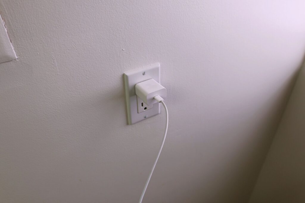 USB-C Cable Connected to Wall Charger in Outlet