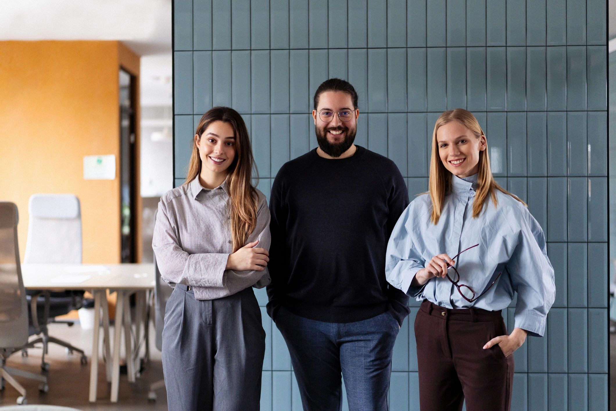 Onten team standing together in a modern office
